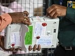 Election Commission of India (ECI) staff break the seal of an Electronic Voting Machine (EVM) as polling agents of various political parties look on before starting tabulation of votes at a counting centre for the Maharashtra state assembly elections in Mumbai on November 23, 2024. (Photo by Indranil Mukherjee / AFP) Election Commission of India (ECI) staff break the seal of an Electronic Voting Machine (EVM) as polling agents of various political parties look on before starting tabulation of votes at a counting centre for the Maharashtra state assembly elections in Mumbai on November 23, 2024. (Photo by Indranil Mukherjee / AFP)