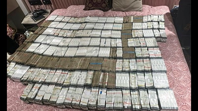 ED officials display cash seized during a search operation in New Delhi on Wednesday. (PTI) ED officials display cash seized during a search operation in New Delhi on Wednesday. (PTI)