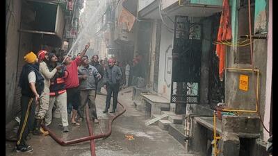 Fire officials douse the fire at Jagatpuri building. (HT) Fire officials douse the fire at Jagatpuri building. (HT)