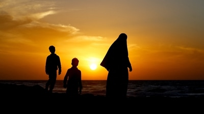 Palestinians walk along the seashore on New Year’s Eve in Gaza City, December 31, 2025.&nbsp; (REUTERS)