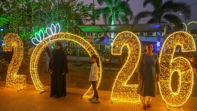 People poses for picture near illuminated decorations on New Year's Eve in Mumbai, India. (AP) People poses for picture near illuminated decorations on New Year's Eve in Mumbai, India. (AP)