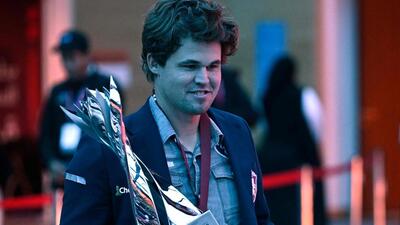 Norway's Magnus Carlsen with the winner's trophy after regaining the Blitz world title in Doha on Tuesday. (AFP)