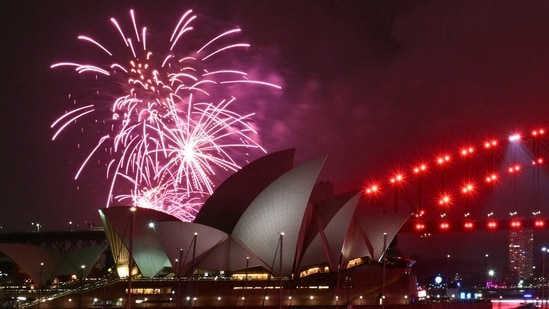 The "family fireworks" light up the Opera House three hours ahead of the main show at midnight in Sydney on New Year's Eve on December 31, 2025.(AFP)