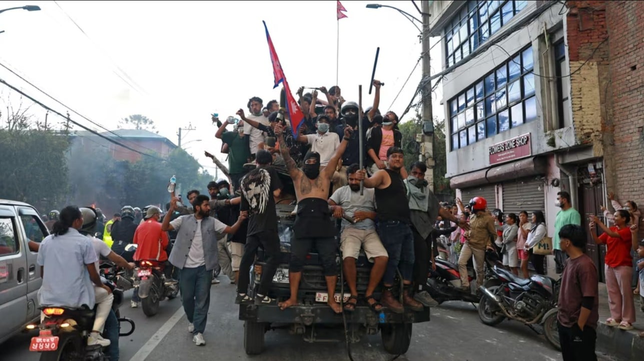Protesters carry Nepal's national flag as they ride a police truck outside the President House in Kathmandu on September 9, 2025. (File Photo/Prabin Ranabhat/AFP)