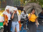 Women shield themselves from the sun in New Delhi.