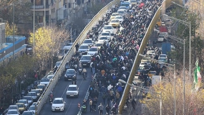 Shopkeepers and traders walk over a bridge during a protest against the economic conditions and Iran's embattled currency in Tehran on December 29, 2025. (AFP) Shopkeepers and traders walk over a bridge during a protest against the economic conditions and Iran's embattled currency in Tehran on December 29, 2025. (AFP)