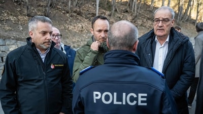 (From L) Head of the Department of Security, Institutions and Sport of the Canton of Valais Stephane Ganzer, Head of the Department of Social Affairs and Culture of the Canton of Valais Mathias Reynard and Swiss President Guy Parmelin talk to Commander of the Valais Cantonal Police Frederic Gisler ahead of their inspection of the area where a fire ripped through the bar Le Constellation during New Year's Eve celebrations in Crans-Montana, on January 1, 2026. (AFP) (From L) Head of the Department of Security, Institutions and Sport of the Canton of Valais Stephane Ganzer, Head of the Department of Social Affairs and Culture of the Canton of Valais Mathias Reynard and Swiss President Guy Parmelin talk to Commander of the Valais Cantonal Police Frederic Gisler ahead of their inspection of the area where a fire ripped through the bar Le Constellation during New Year's Eve celebrations in Crans-Montana, on January 1, 2026. (AFP)