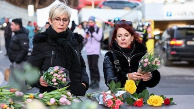 People leave flowers outside the "Le Constellation" bar, in the memory of those who died in the tragedy. (REUTERS)