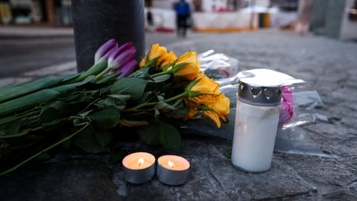 Flowers and candles are left near the "Le Constellation" bar, after a fire and explosion during a New Year’s Eve party. (REUTERS)