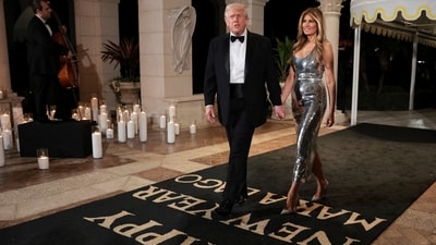 Trump and first lady Melania Trump arrive to attend a New Year's Eve party with members and guests at Trump's Mar-a-Lago . (REUTERS)