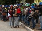 Workers of a construction site use their mobile phones on the street after they evacuated the site during a 6.5 magnitude earthquake in Mexico City.