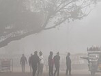 Prayagraj: People gather near an e-rickshaw amid dense fog during a cold winter morning, in Prayagraj, on Friday (PTI)
