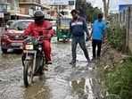In this photograph taken in October 2025, a food delivery rider for Zomato dodges potholes along a street in Bengaluru. In this photograph taken in October 2025, a food delivery rider for Zomato dodges potholes along a street in Bengaluru.