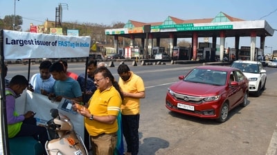 People register for FASTag at a Taswade toll plaza on the Pune-Bangalore national highway. (PTI Photo)