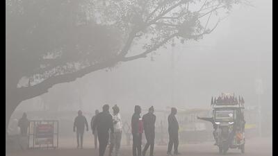 Prayagraj: People gather near an e-rickshaw amid dense fog during a cold winter morning, in Prayagraj, on Friday (PTI) Prayagraj: People gather near an e-rickshaw amid dense fog during a cold winter morning, in Prayagraj, on Friday (PTI)