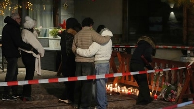 People lay candles and flowers near the Le Constellation bar, where a devastating fire left dead and injured during the New Year's celebrations in Crans-Montana, Swiss Alps, Switzerland. (AP) People lay candles and flowers near the Le Constellation bar, where a devastating fire left dead and injured during the New Year's celebrations in Crans-Montana, Swiss Alps, Switzerland. (AP)