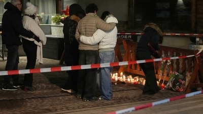 People lay candles and flowers near the Le Constellation bar, where a devastating fire left dead and injured during the New Year's celebrations in Crans-Montana, Swiss Alps, Switzerland. (AP) People lay candles and flowers near the Le Constellation bar, where a devastating fire left dead and injured during the New Year's celebrations in Crans-Montana, Swiss Alps, Switzerland. (AP)