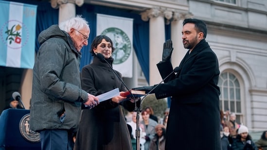 U.S. Sen. Bernie Sanders, I-Vt., left, administers the oath of office to Mayor Zohran Mamdani, right, as Rama Duwaji, center, holds the Quran during Mamdani's inauguration ceremony.(AP)