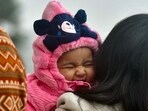 ‘NEED MY BLANKIE’: A baby spotted at the Sukhna Lake amid dipping temperatures in Chandigarh on Friday. (Keshav Singh/HT)
