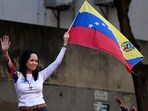 Venezuelan opposition leader Maria Corina Machado waves a national flag during a protest called by the opposition on the eve of the presidential inauguration, in Caracas on January 9, 2025.