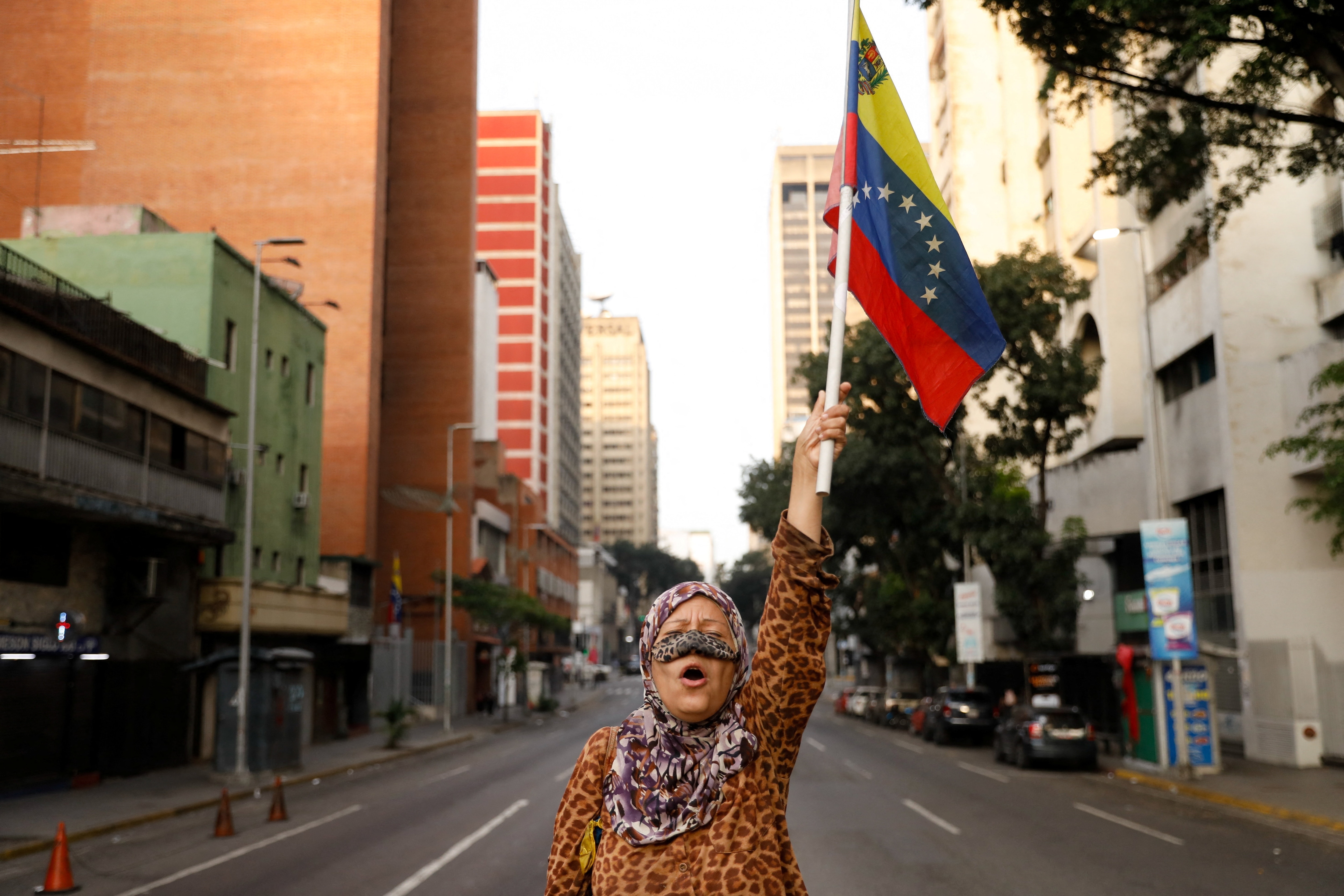 A supporter of Venezuelan President Nicolas Maduro holds a flag of Venezuela on a street near Miraflores Palace, after U.S. President Donald Trump said the U.S. has struck Venezuela and captured Maduro, in Caracas (REUTERS) A supporter of Venezuelan President Nicolas Maduro holds a flag of Venezuela on a street near Miraflores Palace, after U.S. President Donald Trump said the U.S. has struck Venezuela and captured Maduro, in Caracas (REUTERS)