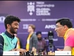 D Gukesh and Viswanathan Anand share a moment during a game.
