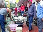 People fill buckets with water from a water tanker as more than 200 people are hospitalised due to water contamination in Indore. (ANI Video Grab)