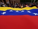 People display a giant Venezuelan flag as they celebrate in Medellín, Colombia, on January 3, 2026, after US forces captured Venezuelan leader Nicolas Maduro. People display a giant Venezuelan flag as they celebrate in Medellín, Colombia, on January 3, 2026, after US forces captured Venezuelan leader Nicolas Maduro.