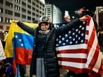 A person reacts holding Venezuelan and U.S. flags as Venezuelan immigrants celebrate after the United States struck Venezuela and captured its President Nicolas Maduro and his wife Cilia Flores, and they were brought to the Metropolitan Detention Center in Brooklyn (MDC Brooklyn), in New York City, U.S., January 3, 2026.