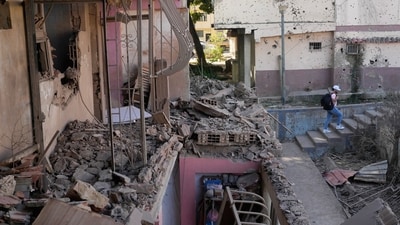 A neighbor walks through an apartment building that residents say was damaged during U.S. military operations to capture Venezuelan President Nicolás Maduro, in Catia La Mar, Venezuela, Sunday, Jan. 4, 2026. AP/PTI(AP01_04_2026_000344A) (AP) A neighbor walks through an apartment building that residents say was damaged during U.S. military operations to capture Venezuelan President Nicolás Maduro, in Catia La Mar, Venezuela, Sunday, Jan. 4, 2026. AP/PTI(AP01_04_2026_000344A) (AP)