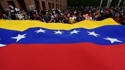 People display a giant Venezuelan flag as they celebrate in Medellín, Colombia, on January 3, 2026, after US forces captured Venezuelan leader Nicolas Maduro. (AFP) People display a giant Venezuelan flag as they celebrate in Medellín, Colombia, on January 3, 2026, after US forces captured Venezuelan leader Nicolas Maduro. (AFP)