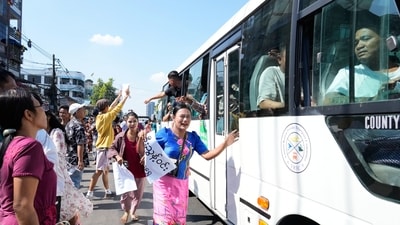 Released prisoners, in a bus, are welcomed by family members and colleagues after they left Insein Prison on Sunday. (AP) Released prisoners, in a bus, are welcomed by family members and colleagues after they left Insein Prison on Sunday. (AP)