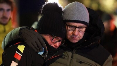 People embrace outside the "Le Constellation" bar, after a fire and explosion during a New Year's Eve party where people died and others were injured, in the upscale ski resort of Crans-Montana in southwestern Switzerland, January 2, 2026. (REUTERS)