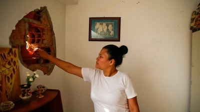 A woman shows damage in a residential building, after the U.S. launched a strike on Venezuela, capturing its President Nicolas Maduro and his wife Cilia Flores, in Caracas, Venezuela January 4, 2026.&nbsp; (REUTERS)