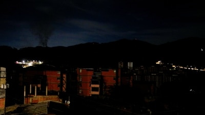 Smoke rises near Fort Tiuna during a full blackout, following explosions and loud noises, amid rising tensions between administrations of U.S. President Donald Trump and Venezuelan President Nicolas Maduro, in Caracas, Venezuela, January 3, 2026.&nbsp; (REUTERS)