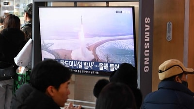 People sit in front of a television screen showing a news broadcast with file footage of a North Korean missile test, at a train station in Seoul on Sunday (AFP) People sit in front of a television screen showing a news broadcast with file footage of a North Korean missile test, at a train station in Seoul on Sunday (AFP)
