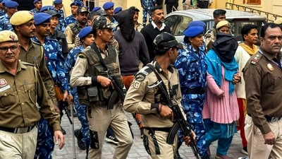 Security personnel escort accused, with faces covered, in the car bomb blast near Red Fort while bringing them to the Patiala House Court (PTI/File photo) Security personnel escort accused, with faces covered, in the car bomb blast near Red Fort while bringing them to the Patiala House Court (PTI/File photo)