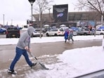 A fan shovels snow before the game between the New York Jets and Buffalo Bills at Highmark Stadium in Orchard Park, New York. 