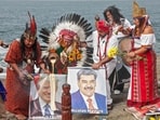 A group of shamans and healers from the coastal, Andean and Amazonian regions of Peru hold images of US President Donald Trump and ousted Venezuelan President Nicolas Maduro.