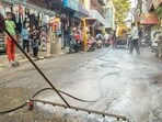 Indore Municipal Corporation workers conduct a cleanliness drive after several people were affected due to the consumption of contaminated water in the Bhagirathpura area. 