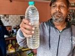 Indore: A person shows a sample of the drinking water that is being collected following a diarrhoea outbreak caused by contaminated water, at Bhagirathpura area.