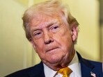 President Donald Trump listens as he was speaking with reporters while in flight on Air Force One, Sunday, Jan. 4, 2026.
