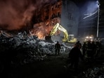 Rescuers work at the site of an apartment building hit by a Russian air strike, amid Russia's attack on Ukraine, in Kharkiv, Ukraine.