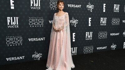 Ariana Grande dazzled in her Glinda-coded custom pink satin off-the-shoulder gown by Alberta Ferretti at the Critics Choice Award. It features a white embroidered tulle&nbsp;floor-length cape overlay embellished with silver floral appliqués.&nbsp; (Richard Shotwell/Invision/AP)