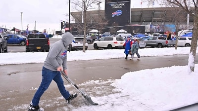 A fan shovels snow before the game between the New York Jets and Buffalo Bills at Highmark Stadium in Orchard Park, New York. (Getty Images via AFP) A fan shovels snow before the game between the New York Jets and Buffalo Bills at Highmark Stadium in Orchard Park, New York. (Getty Images via AFP)