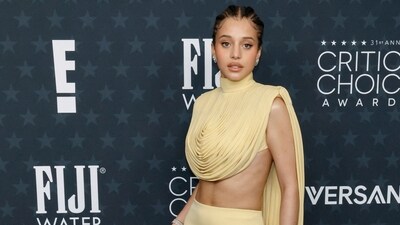 Chase Infiniti bared her abs in this gorgeous pale yellow two-piece ensemble from Louis Vuitton. The look consists of a sleeveless draped top and flared skirt.&nbsp; (Getty Images via AFP)