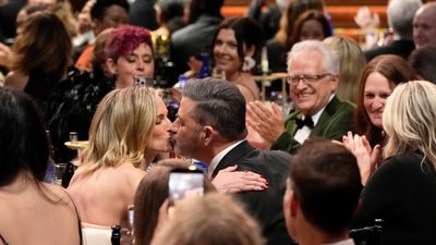 Jimmy Kimmel, right, kisses his wife, Molly McNearney, in the audience during the 31st Annual Critics Choice Awards on Sunday, Jan. 4, 2026, at The Barker Hanger in Santa Monica, Calif. (AP Photo/Chris Pizzello) (Chris Pizzello/Invision/AP)