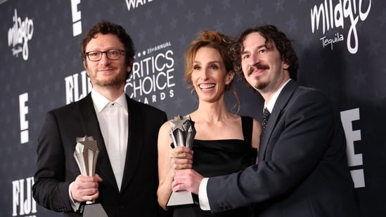 (L-R) US film director Akiva Schaffer, producers Erica Huggins and Danny Bonacci pose in the press room with the Best Comedy Film award for "The Naked Gun" during the 31st Annual Critics Choice Awards at Barker Hangar in Santa Monica, California, on January 4, 2026. (Photo by Michael Tran / AFP)(AFP)