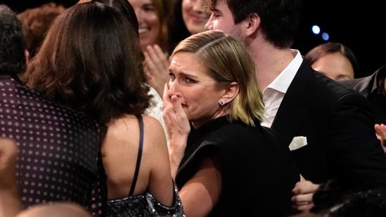 Rhea Seehorn, center, reacts to winning the award for best actress in a drama series for "Pluribus" during the 31st Annual Critics Choice Awards on Sunday, Jan. 4, 2026, at The Barker Hanger in Santa Monica, Calif. (AP Photo/Chris Pizzello)(Chris Pizzello/Invision/AP)