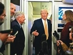 US President Donald Trump, accompanied by Senator Lindsey Graham, speaks with reporters aboard Air Force One. (AFP)